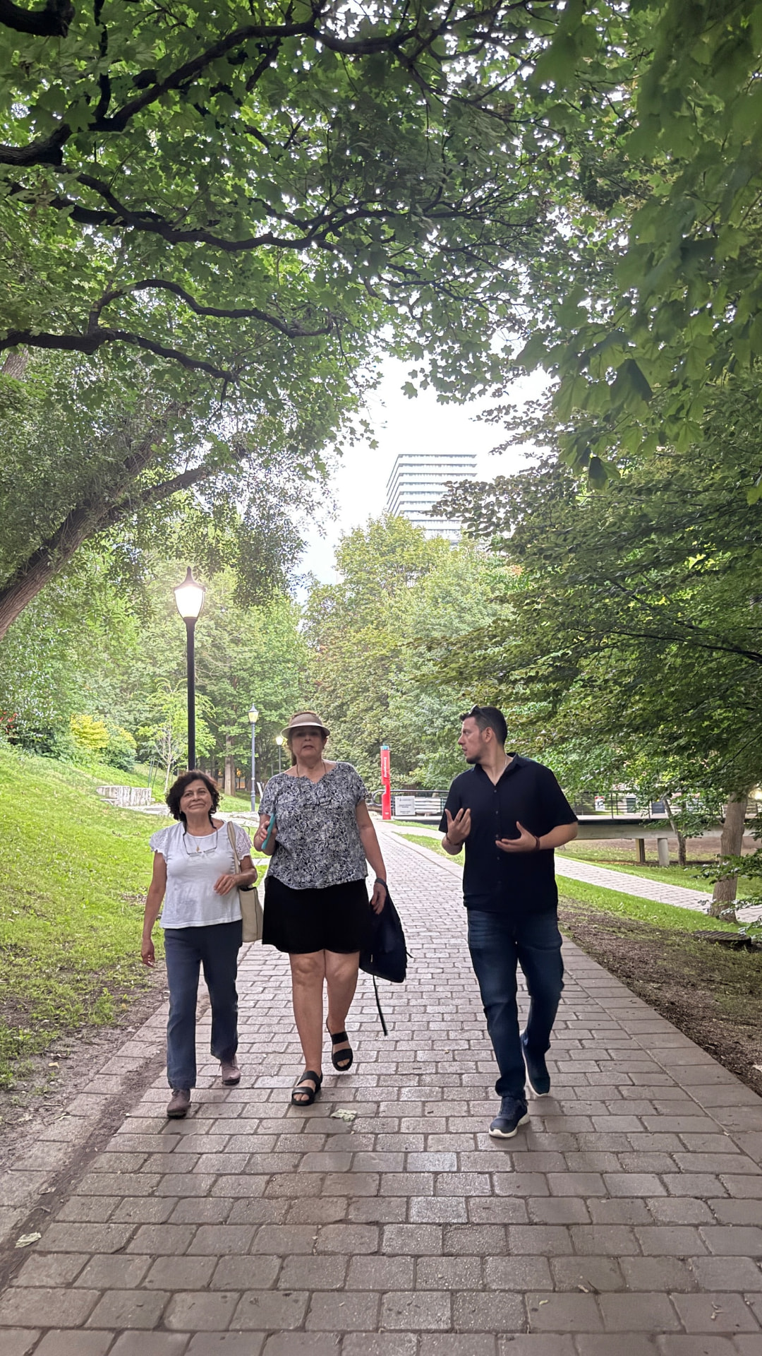 Mike walking and talking with guests along the green Philosopher's Walk path