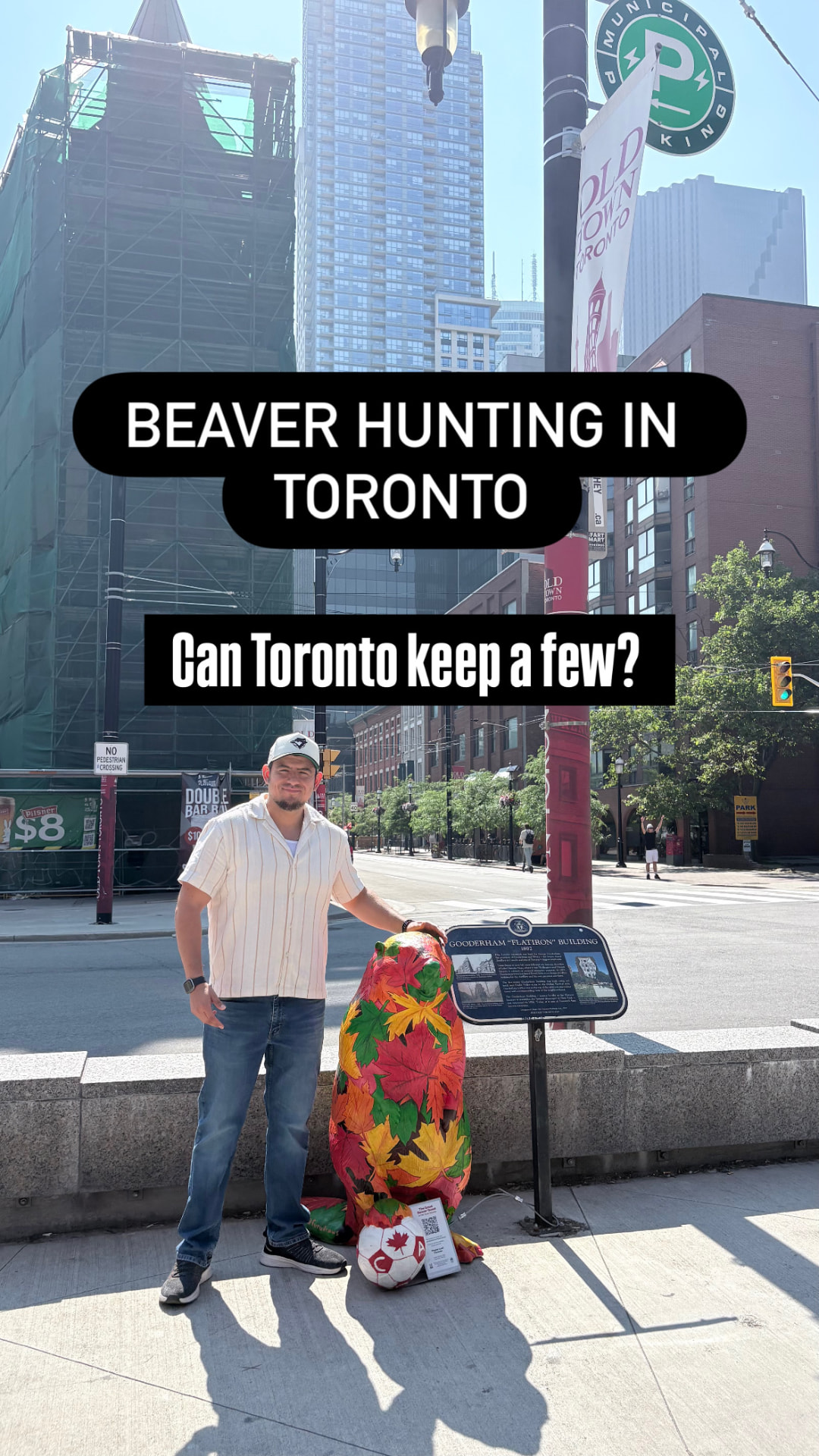 Mike beside a maple-leaf painted public-art beaver sculpture in Old Town Toronto