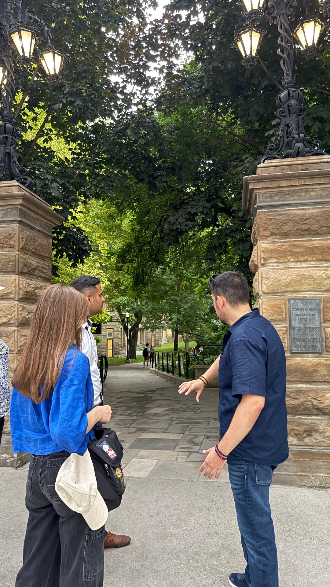 Mike guiding guests beside the stone and iron gates at Philosopher's Walk