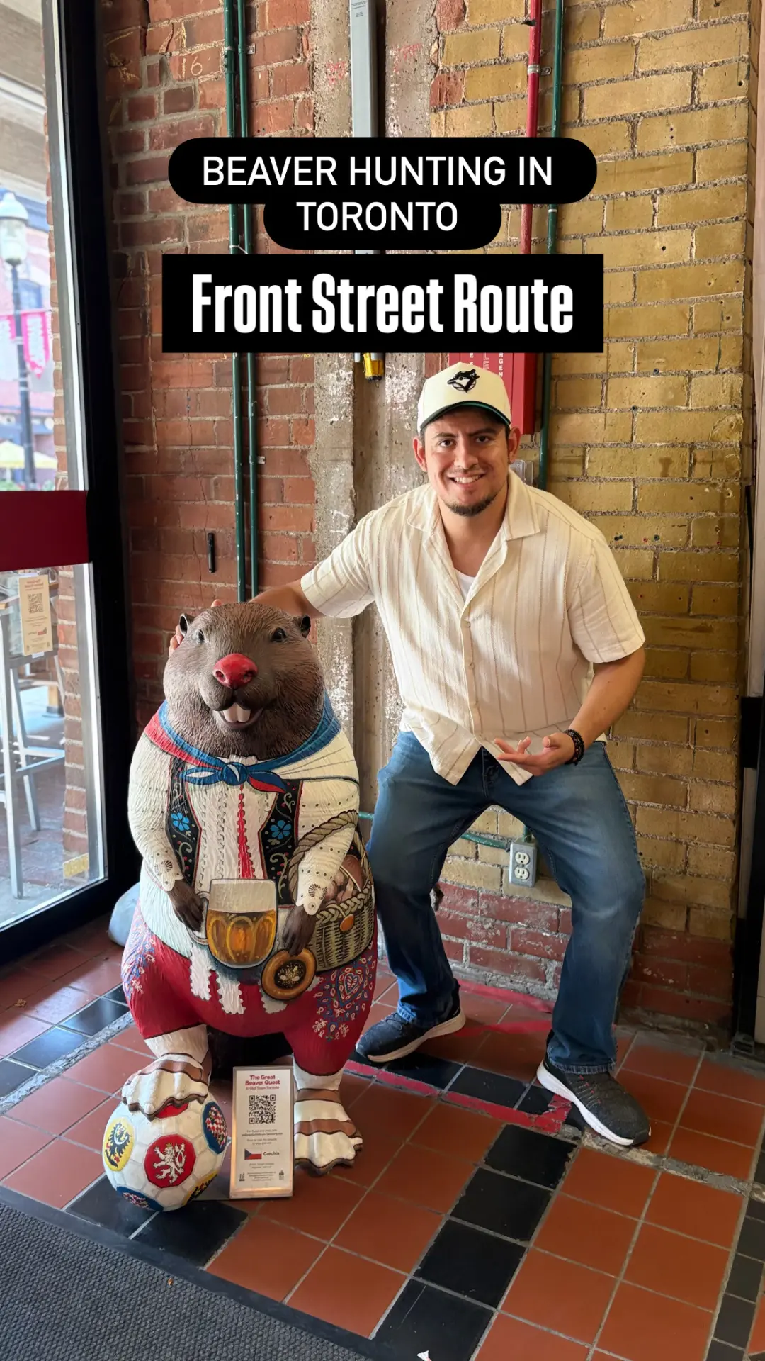Mike posing with a Czech-themed beaver sculpture inside a Front Street doorway